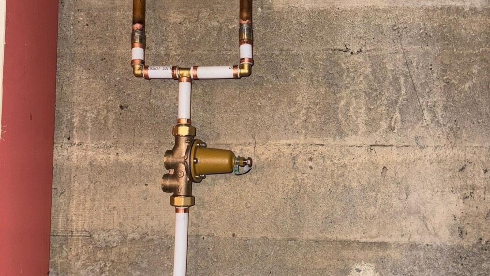 New pressure-control valve and supply piping installed in a utility space